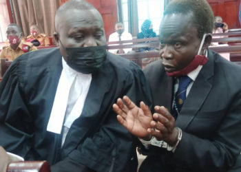 Lawyer Caleb Alaka together with the accused Thomas Kwoyelo. (IMAGE: URN )