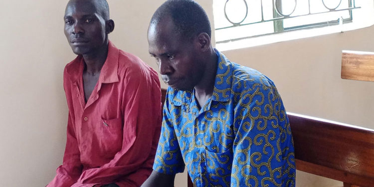 In court, Raymond Esanyu (in a blue kitenge shirt) appeared.