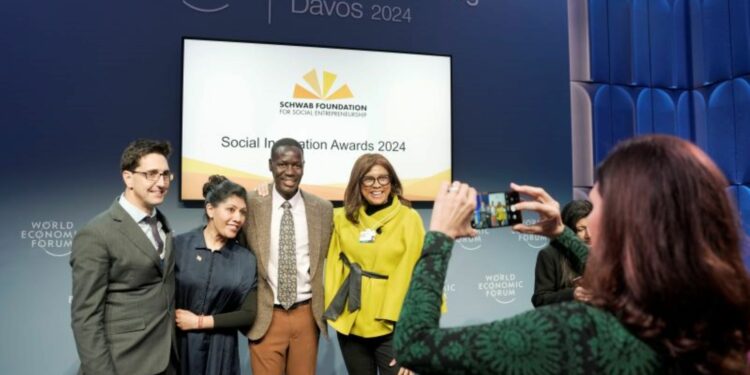 Gerald Abila poses with partners from Echoing Green